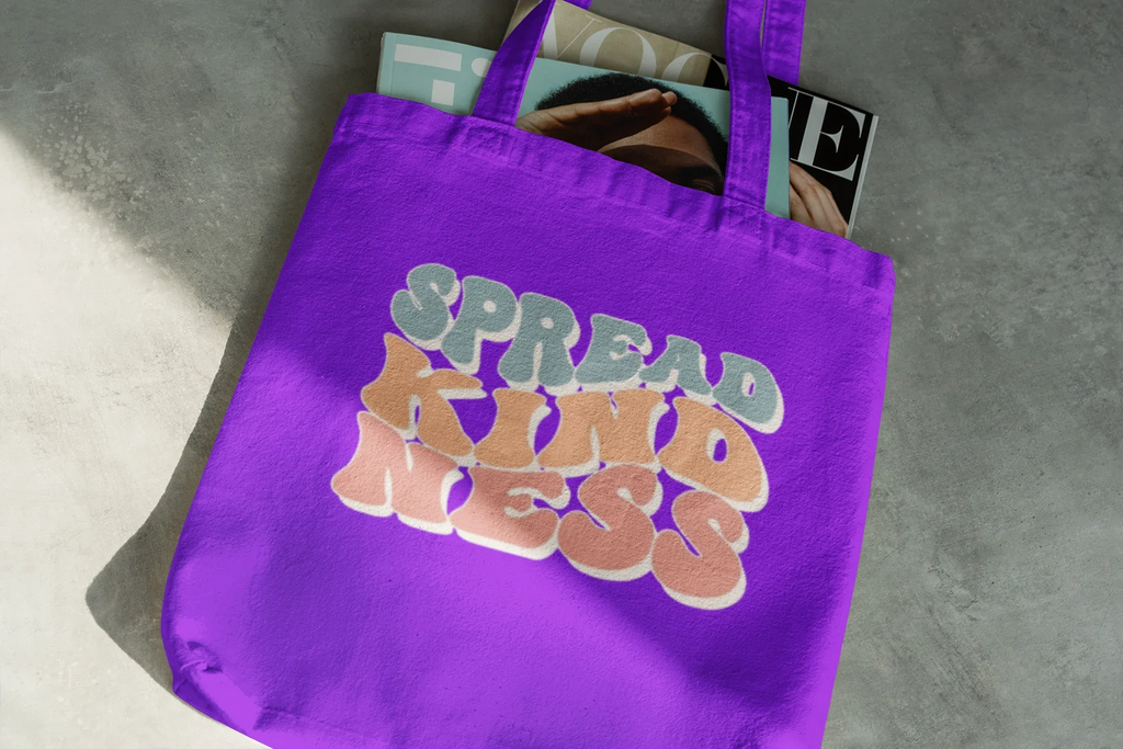 Purple cotton tote bag with 'SPREAD KINDNESS' graphic on the front