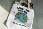 White tote bag with “Love the Earth” text and globe illustration