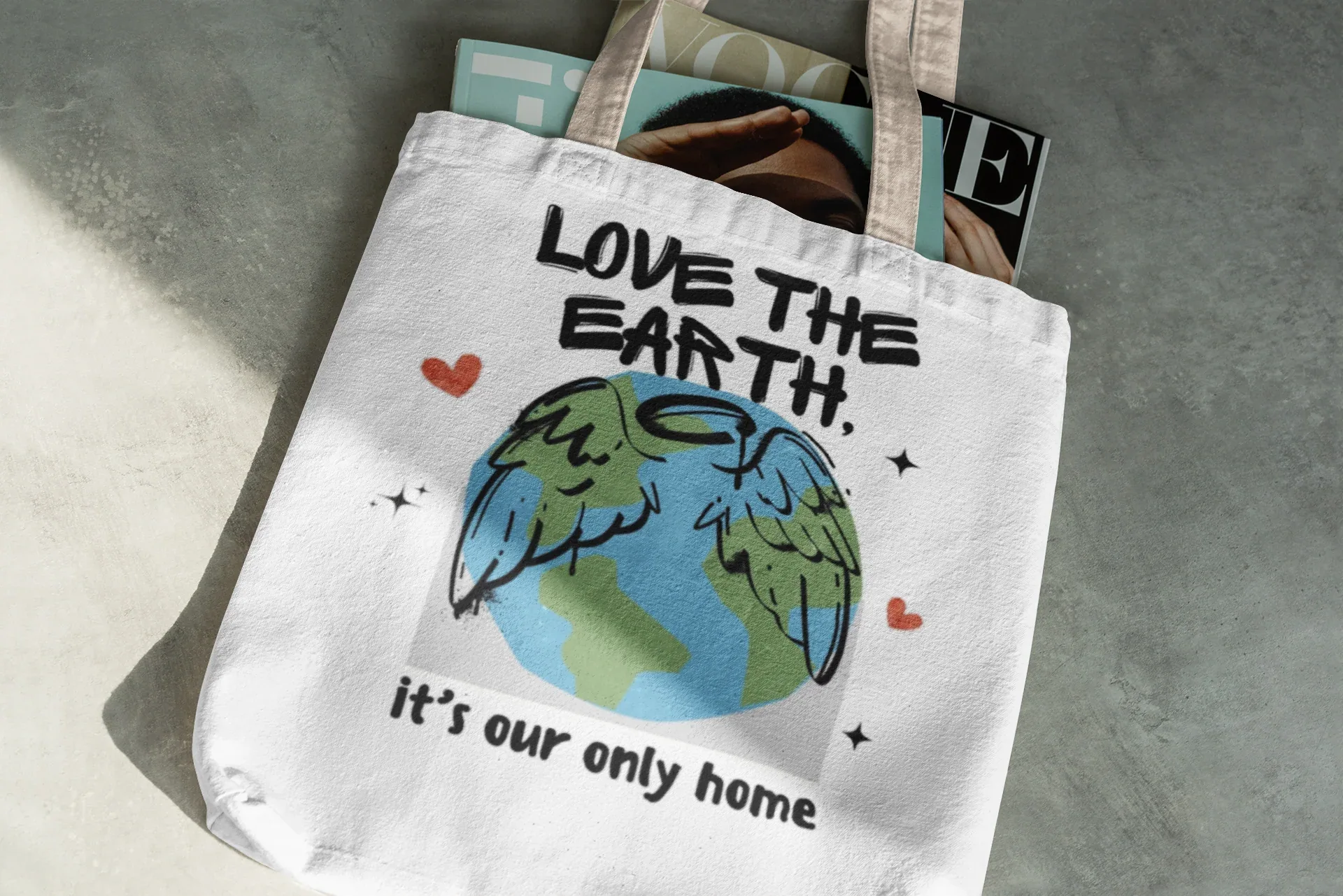 White tote bag with “Love the Earth” text and globe illustration