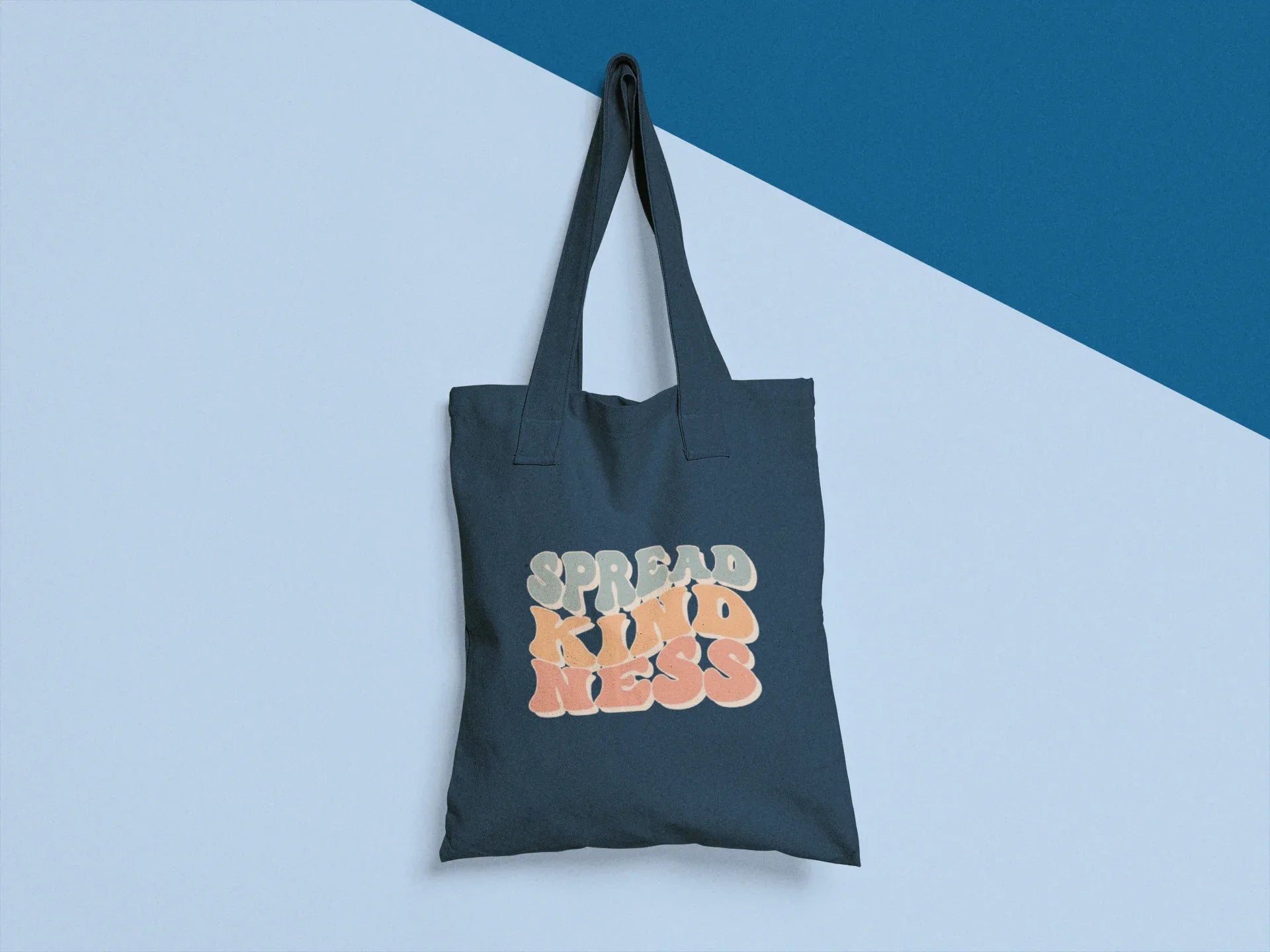 Dark gray cotton tote bag with 'SPREAD KINDNESS' graphic on the front