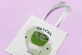 White matcha-themed tote bag with long handles and green drink graphic