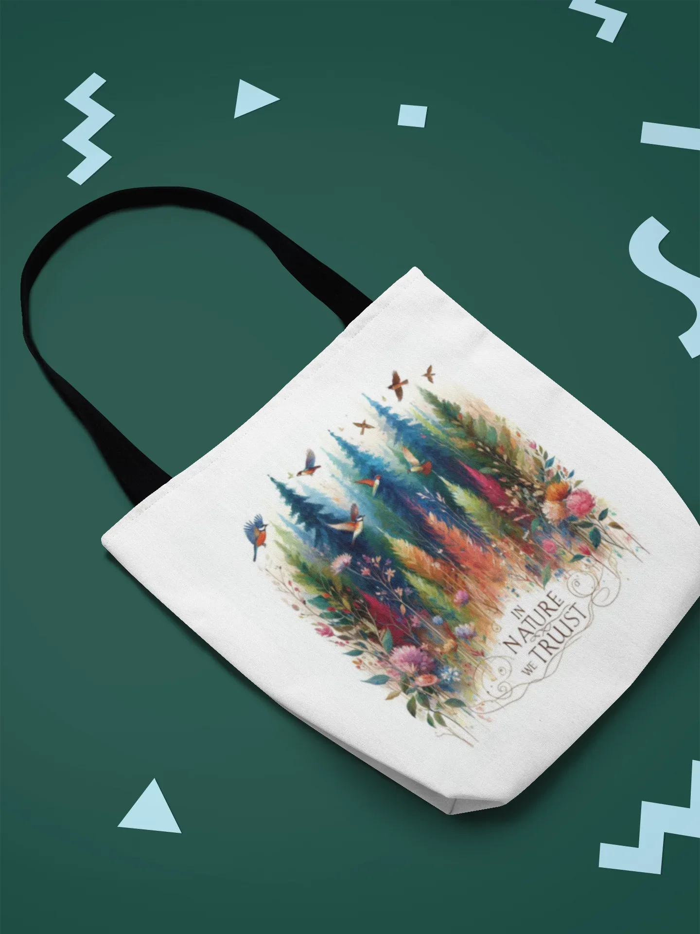 White tote bag with black handles, colorful forest and birds design with Nature Trust logo