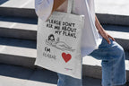 White canvas tote bag with bold quote, “Please don’t ask me about my plans,” and red heart