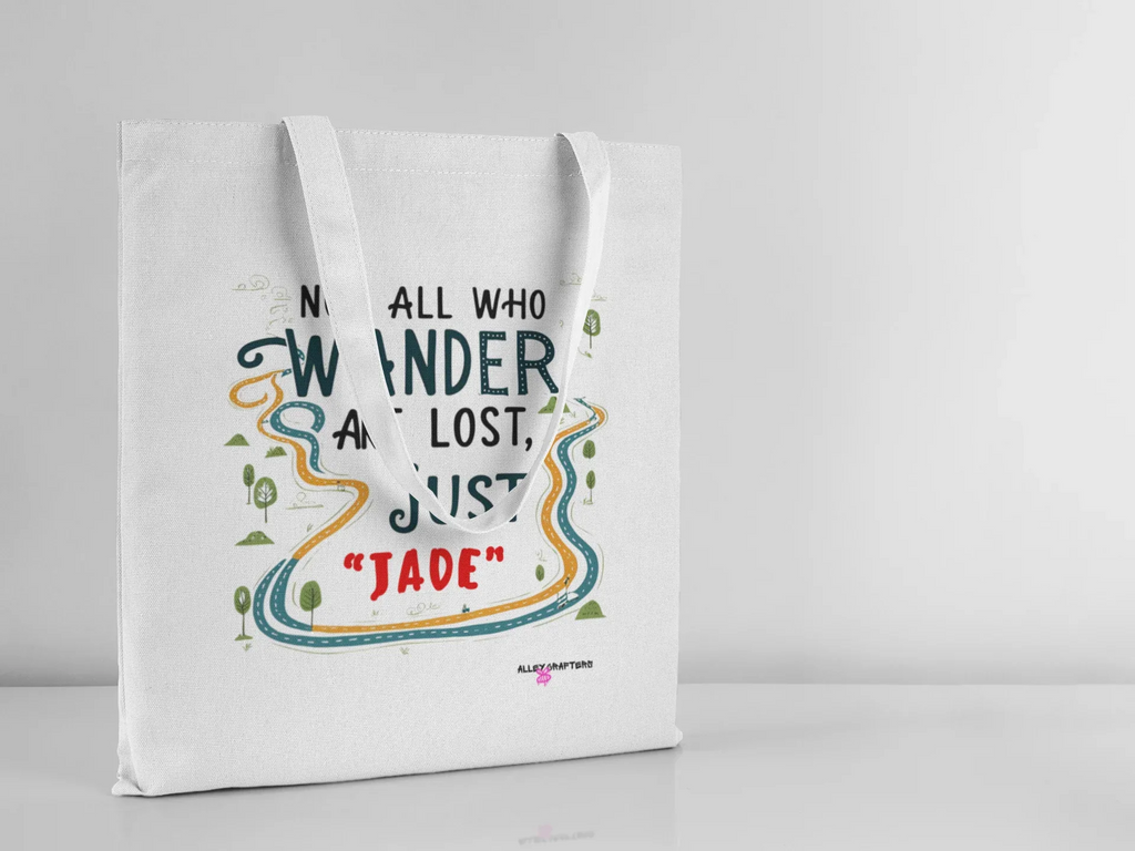 White canvas tote bag with long handles, front quote graphic in colorful outline