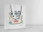 White canvas tote bag with long handles, front quote graphic in colorful outline
