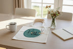 Cream cotton tote bag on table with circular 'Tote.' logo print