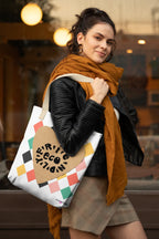 White heart-print tote bag with tan heart graphic, multicolor diamonds, handles on top
