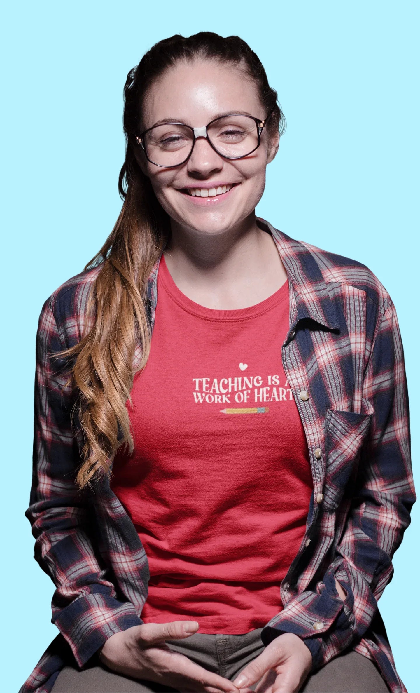 Red unisex T-shirt with crew neck and “Teaching is a Work of Heart” chest print