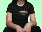 Unisex T-shirt, black crew neck, 'Teaching is a work of heart' chest print with heart
