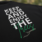 Close-up of black sweatshirt graphic: “Keep Calm and Enjoy the waves” with green line details.