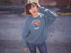 Light blue crewneck sweatshirt with space graphic logo at center chest.