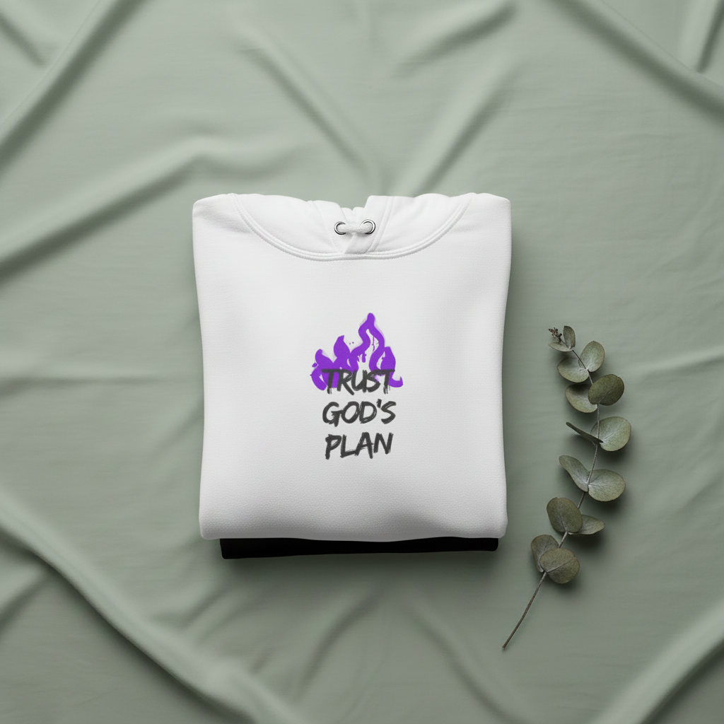 White hoodie folded with drawstring hood and purple “TRUST GOD’S PLAN” logo on chest.