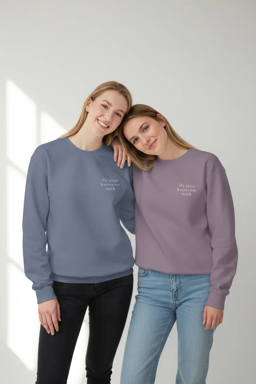 Mauve and blue crewneck sweatshirts with small chest text, worn by models