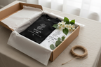 Two tees in open kraft gift box — tissue paper — jasmine