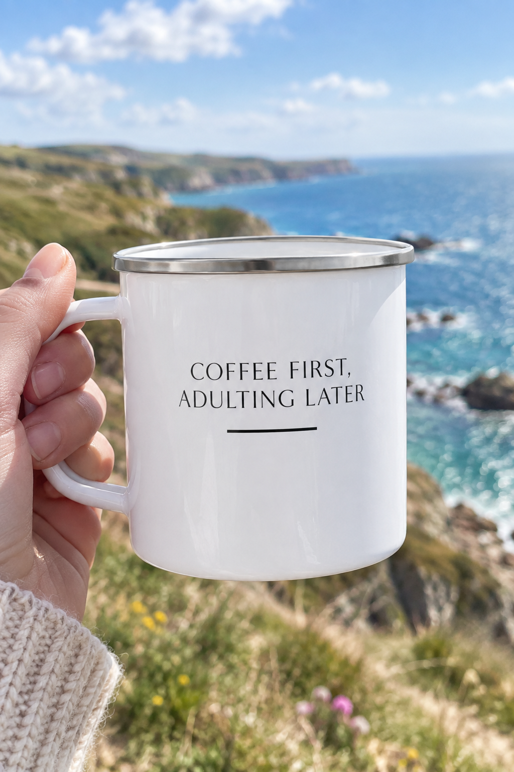 White enamel camping mug with 'Coffee first, adulting later' text, silver rim