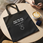 Black cotton tote bag with ring icon and 'does this ring make me look engaged?'.