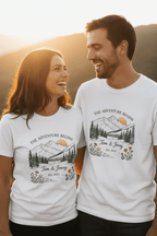 Two white couples T-shirts worn by a pair, each with mountain landscape floral print