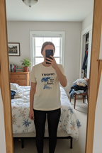 Cream Tropic Like It's Hot T-shirt with blue palm tree and chair graphic at center
