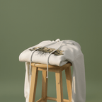 White graphic hoodie draped on stool with hood and Roots text front graphic