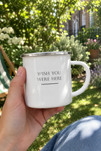 White enamel camping mug with 'Wish you were here' text, silver rim