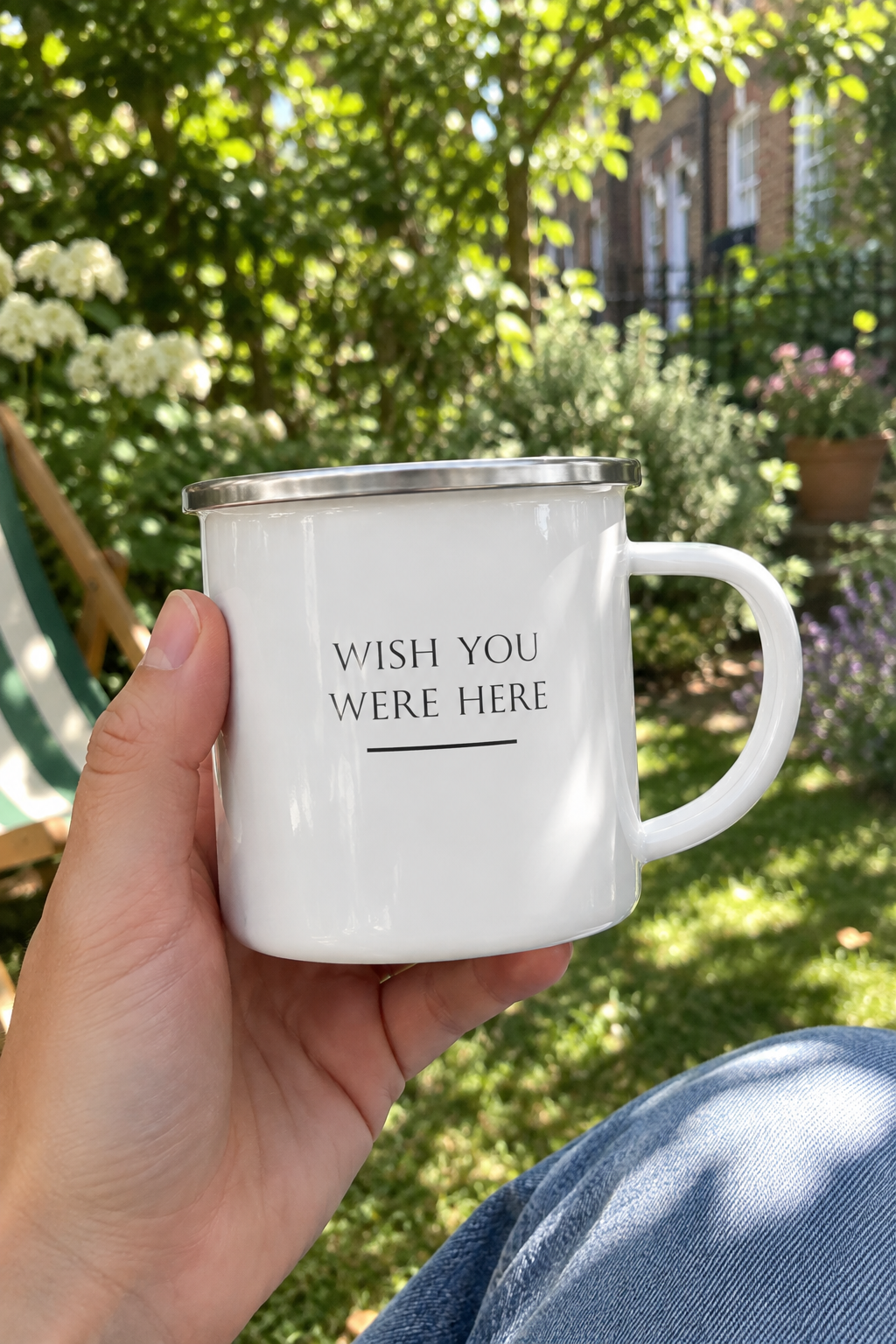 White enamel camping mug with 'Wish you were here' text, silver rim