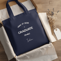 Navy tote bag with 'Class of 2026', 'GRADUATE (finally)', and stitched name on front