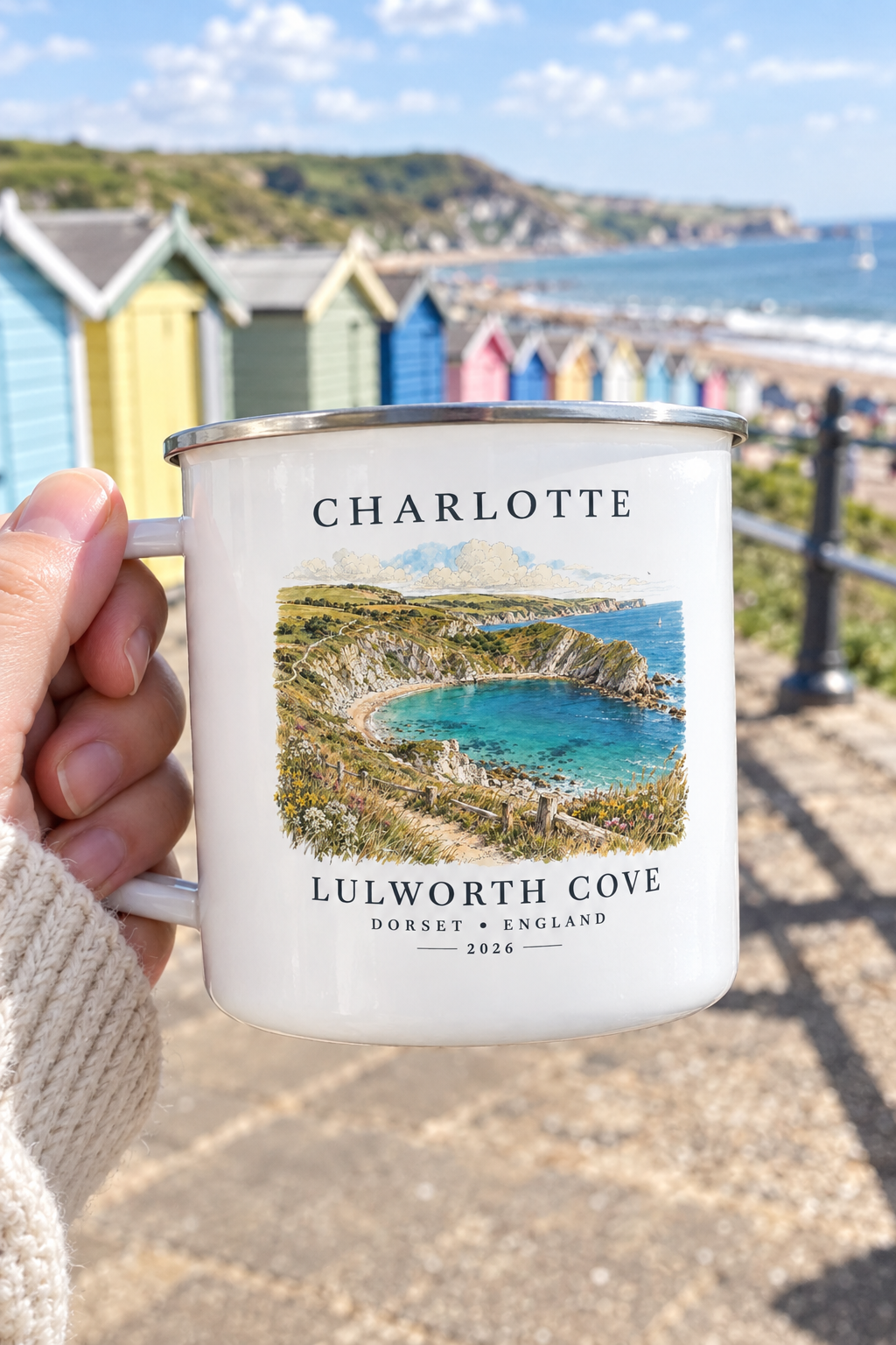 White enamel camping mug with silver rim, 'CHARLOTTE' name and Lulworth Cove landscape print