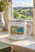 White enamel camping mug with silver rim, 'JAMES' name and Lulworth Cove landscape print