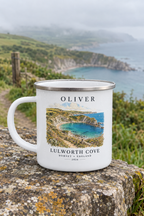 White enamel camping mug with silver rim, 'OLIVER' name and Lulworth Cove landscape print