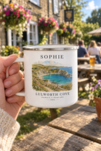 White enamel camping mug with silver rim, 'SOPHIE' name and Lulworth Cove landscape print