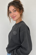 Dark grey crewneck sweatshirt with small front text "My sister knows too much"