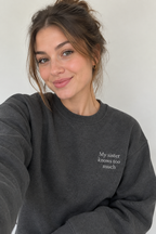Dark grey crewneck sweatshirt with small front text "My sister knows too much"
