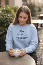 Light blue personalized crewneck sweatshirt with name Zoe and coffee, trees, mountains