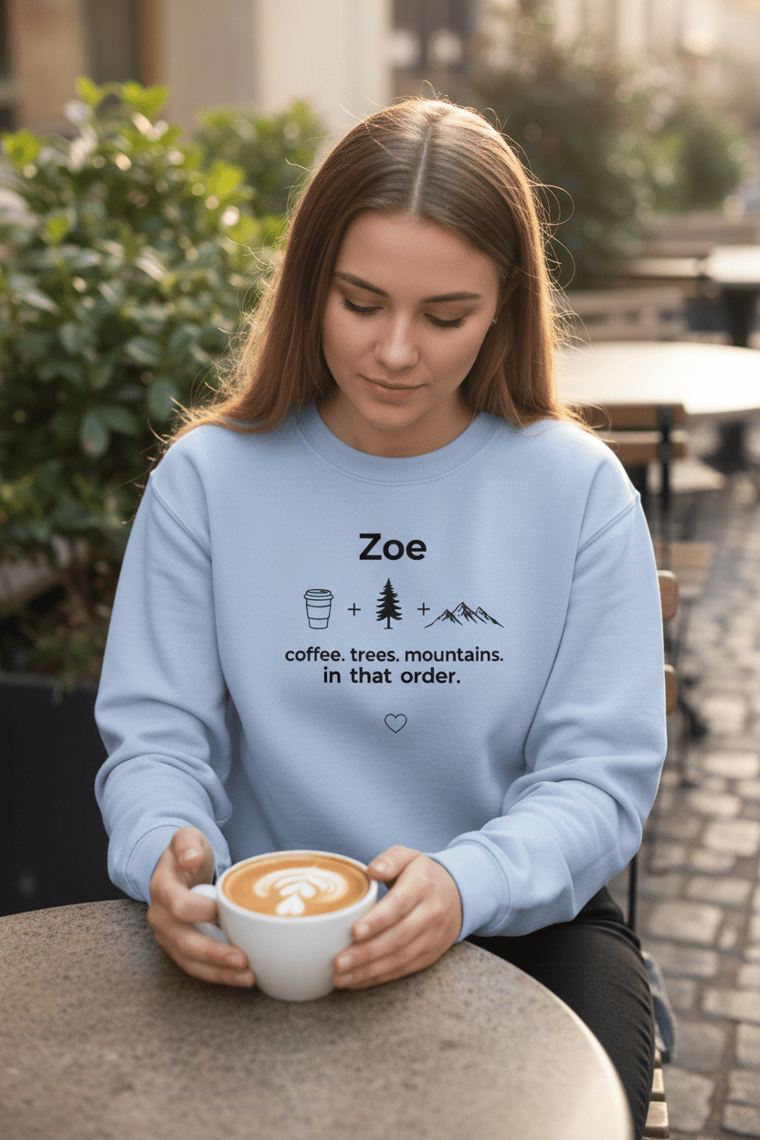 Light blue personalized crewneck sweatshirt with name Zoe and coffee, trees, mountains