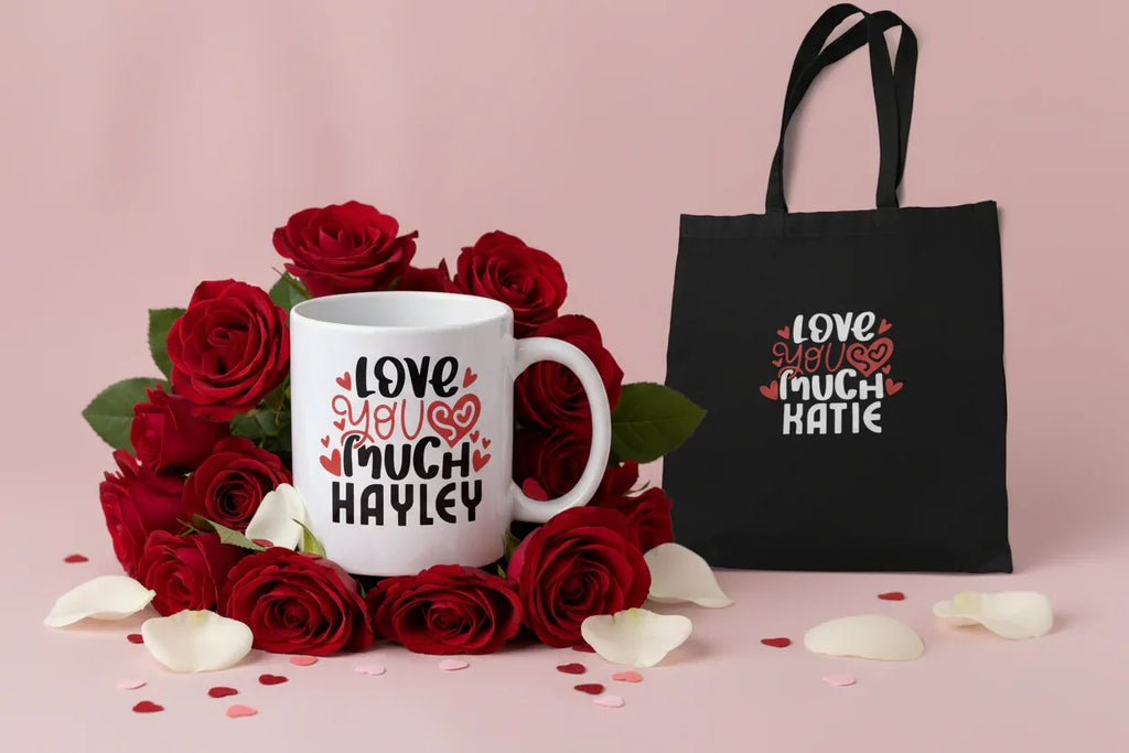 Black tote bag with printed hearts and text: “LOVE YOU MUCH KATIE”