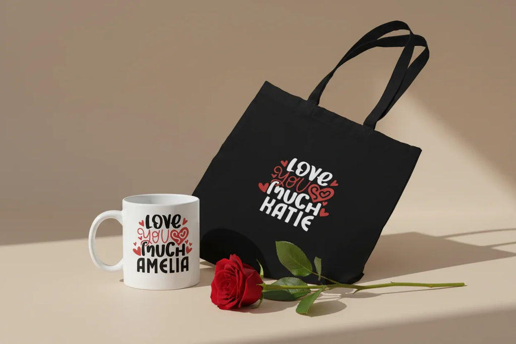 Black tote bag with colorful heart text graphic on front