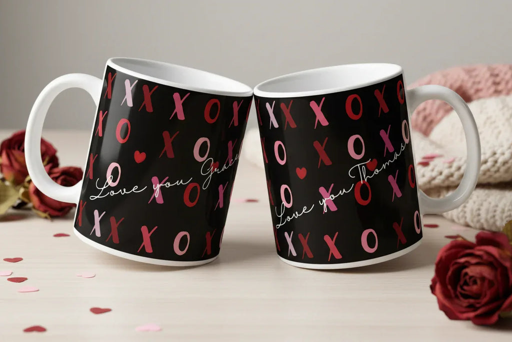 Pair of personalised mugs, black with pink XO and red hearts, white handles