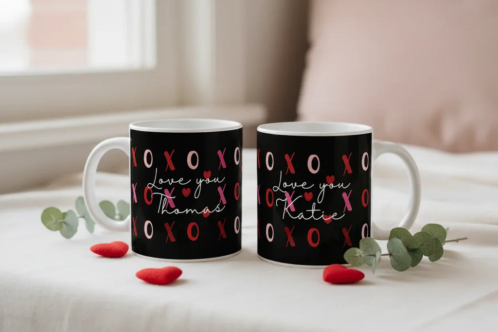 Pair of black ceramic mugs with red XO hearts and “Love you” personalized names