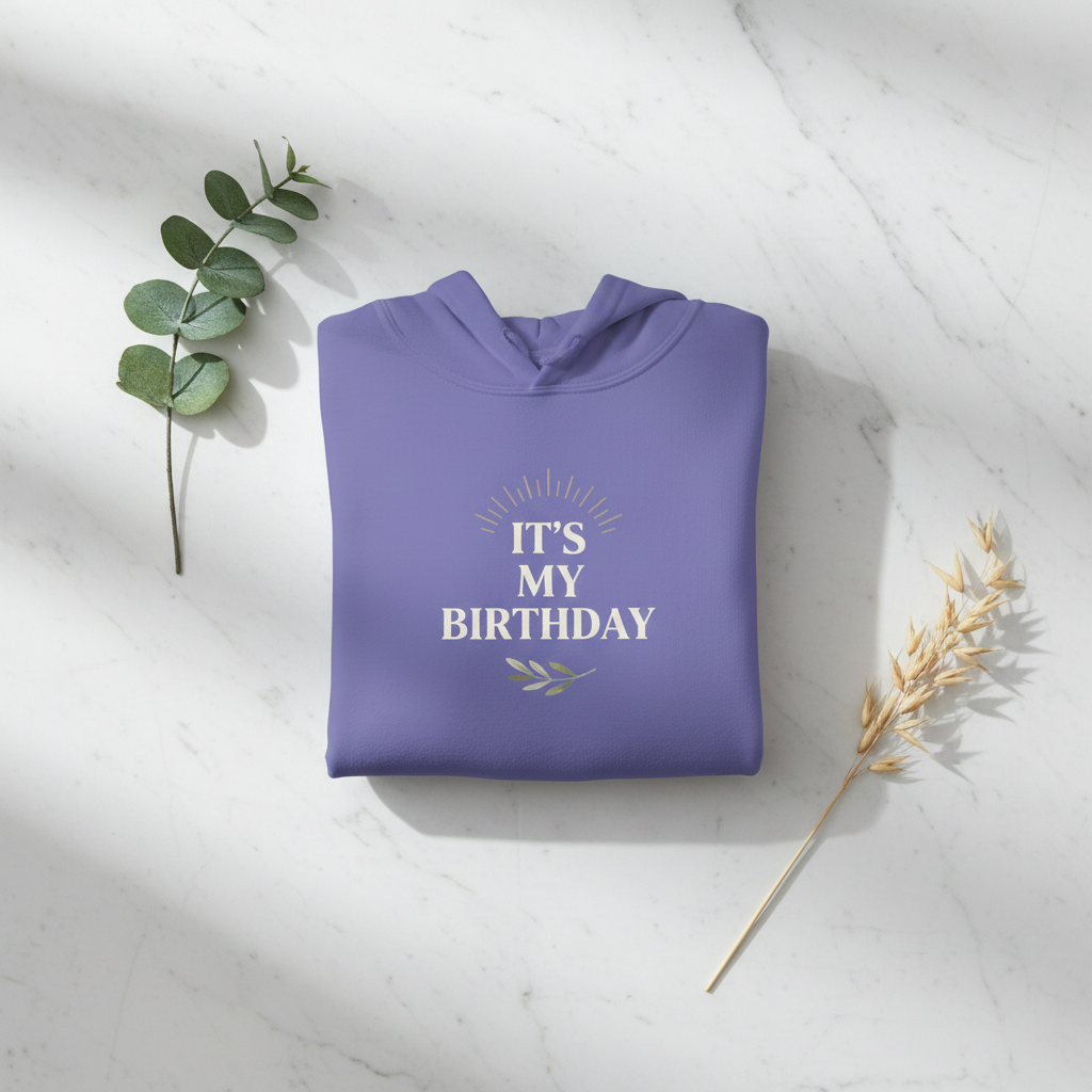 Purple hooded sweatshirt, folded flat, with 'It's My Birthday' chest graphic