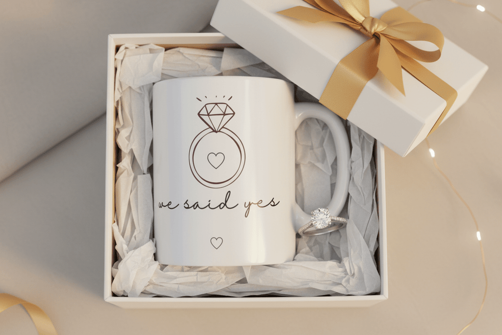 White ceramic mug with diamond ring graphic, 'we said yes' text, in gift box