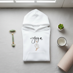 White hoodie with 'eyoga' script and duck yoga pose graphic, flat lay