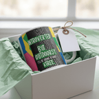White mug with colorful nature quote and tied gift tag