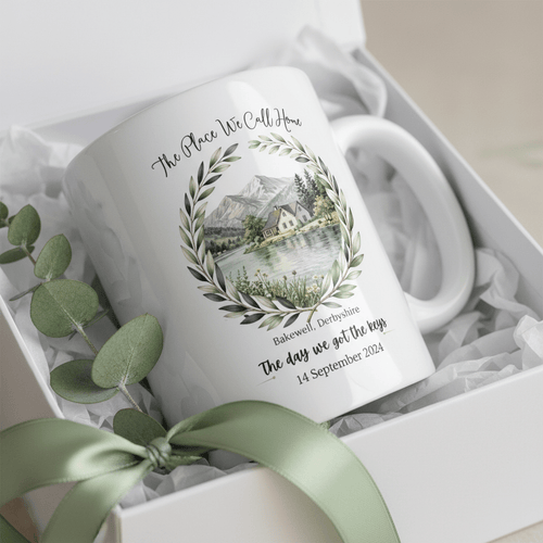 White ceramic mug in gift box with lake scene wreath and date 14 September 2024
