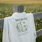 White hoodie close-up, back “Trust God’s Plan” moon and greenery graphic