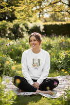 White crewneck sweatshirt with woodland animal Happy Birthday graphic worn by model