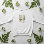 White sweatshirt with crew neck and woodland animals Happy Birthday graphic on chest