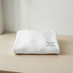 White crew-neck sweatshirt with “My sister knows too much” chest print