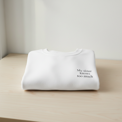 White sweatshirt with black text folded