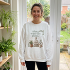 White crewneck sweatshirt on a model, featuring front plant-themed slogan graphic