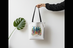 White canvas tote bag with forest scene print and top handles